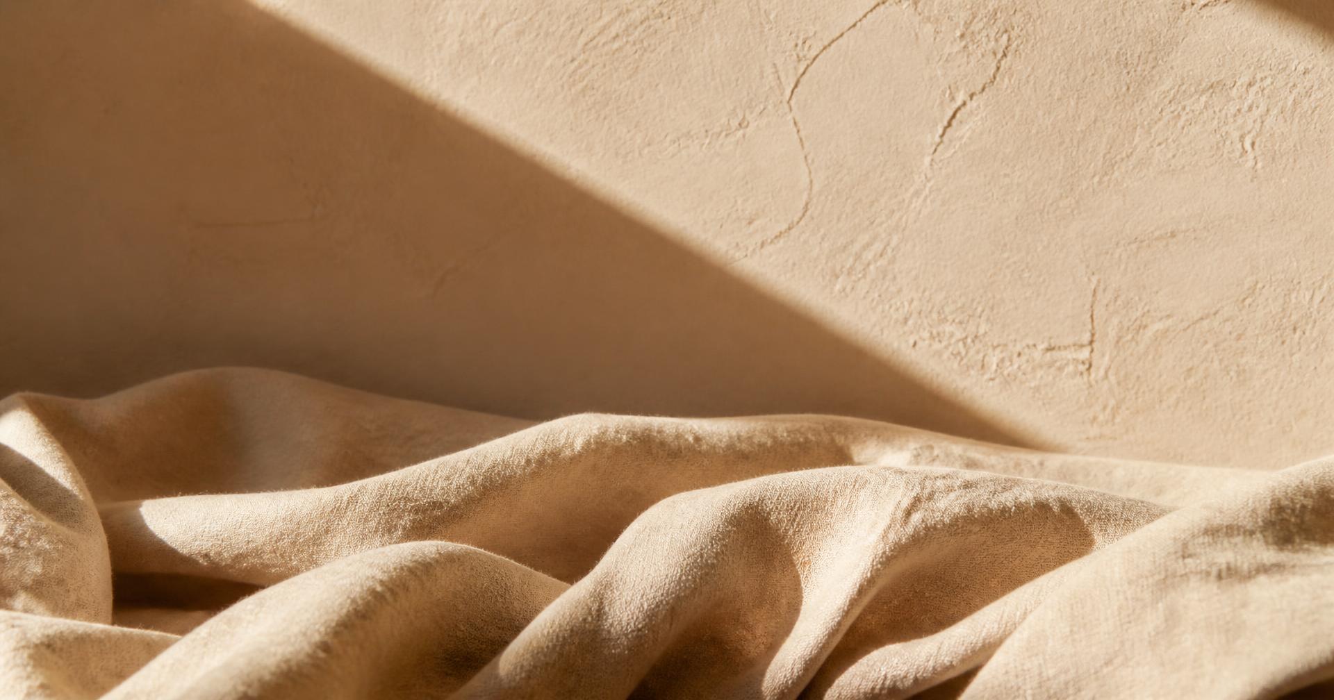 Warm linen folds in soft morning light